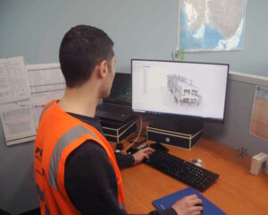 rhima employee working on a drawing for a customer